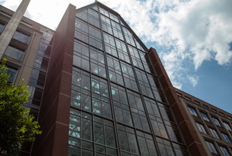 A gavel striking a sounding block in a courtroom, representing legal challenges and rulings.