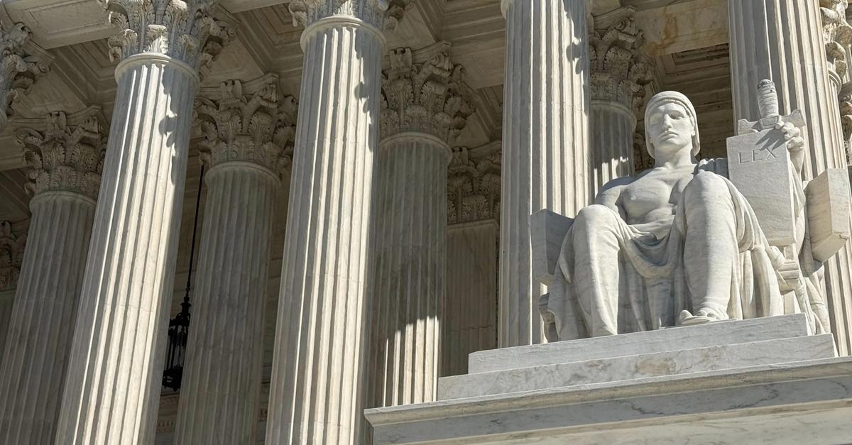 The Supreme Court building against a dramatic sky.