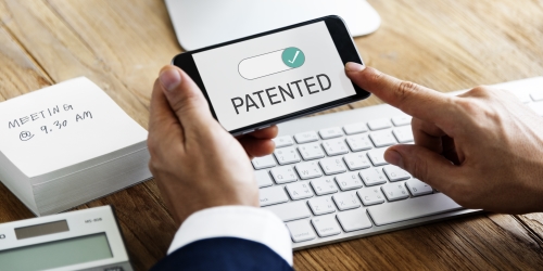 Diagram showing a business concept funneling into technological components, with a patent shield protecting the tech.