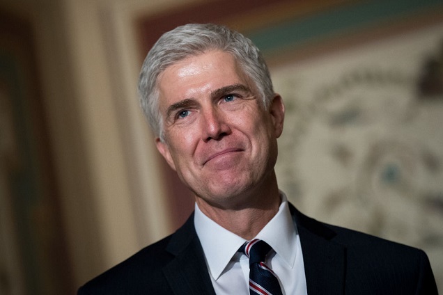 Justice Neil Gorsuch speaking at a podium