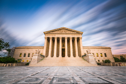The exterior of the Supreme Court building with a gavel on a desk.