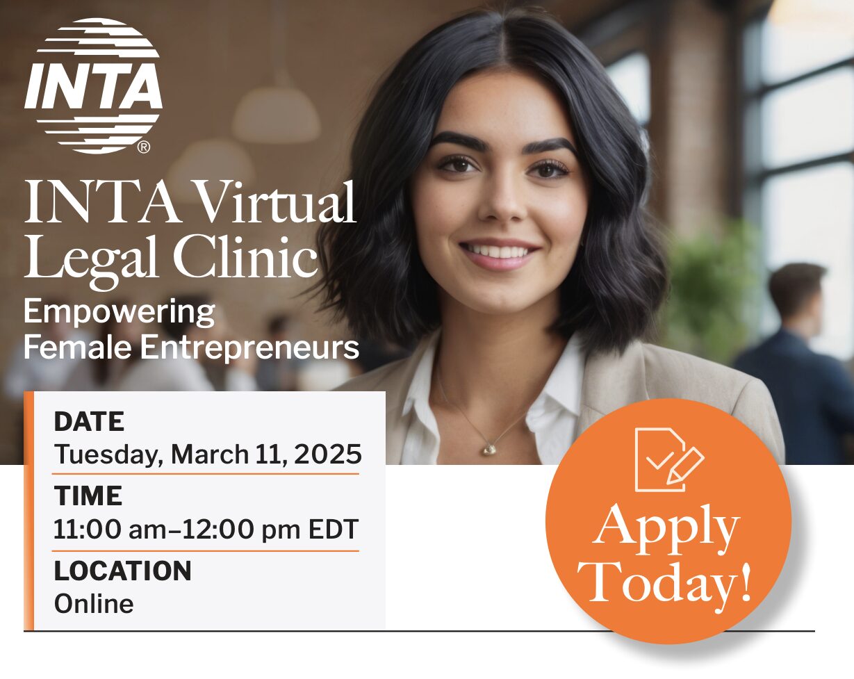 A diverse group of women collaborating around a table, looking at documents and laptops, symbolizing entrepreneurship and collaboration.