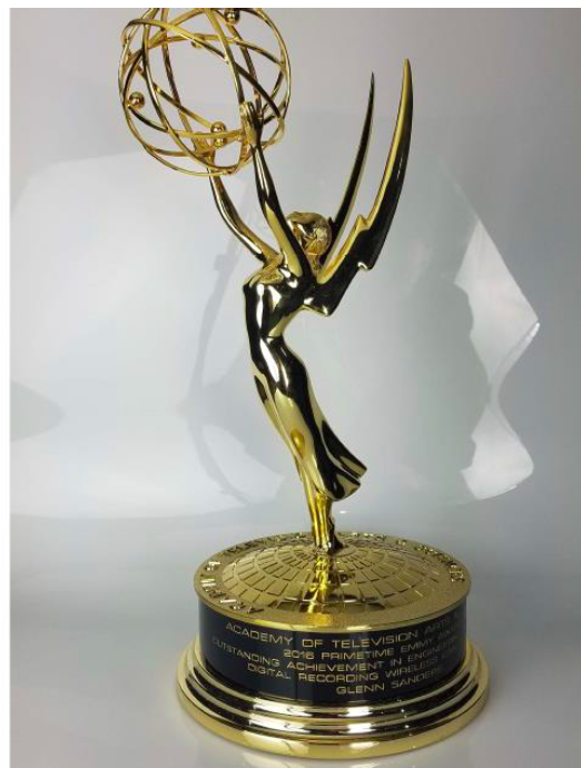 A person wearing a small, discreet wireless microphone transmitter on their clothing.